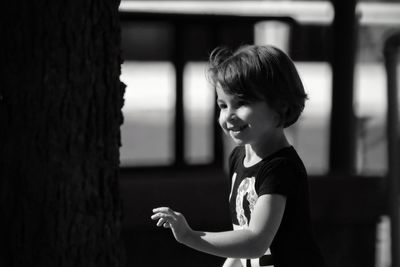 Side view of girl holding indoors