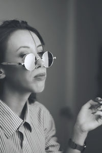 Close-up of young woman wearing sunglasses 