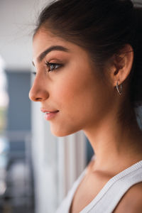 Close-up portrait of young woman looking away