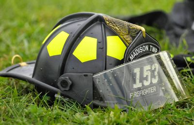 Close-up of firefighters helmet on grass