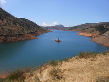 Scenic view of lake against blue sky