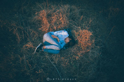 High angle view of woman relaxing on field