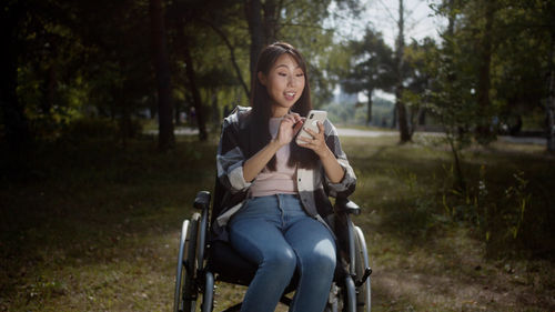 Young woman sitting on field