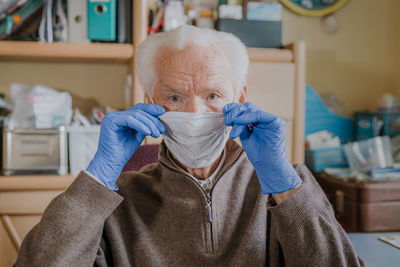 Portrait of man wearing mask at home