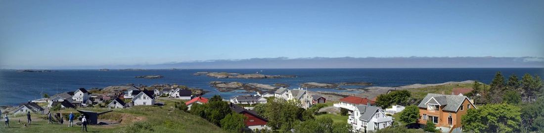 High angle view of sea and buildings against sky