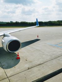 Cropped image of airplane on airport runway