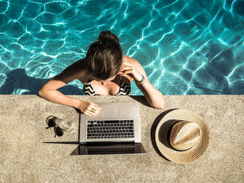 High angle view of woman lying on swimming pool