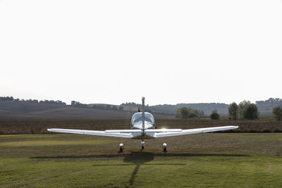 Airplane at airfield during sunny day