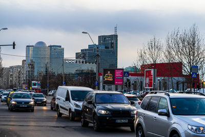 Traffic on road against buildings in city