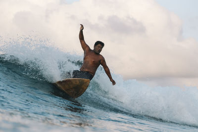 Surfer on a wave at day time