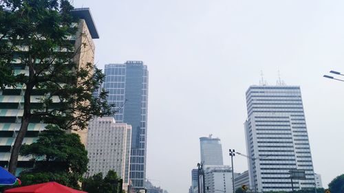 Low angle view of modern buildings against clear sky