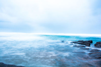 Scenic view of sea against blue sky