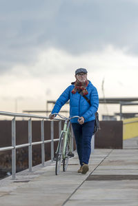 Low angle view of man standing against sky