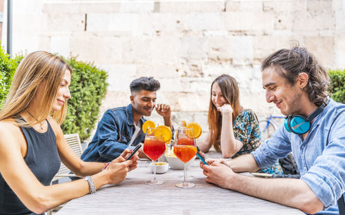 Friends holding drink