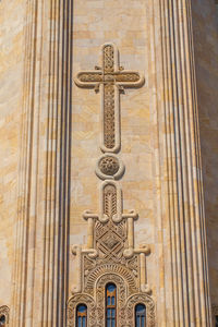 Low angle view of cross pattern on church wall