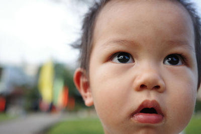 Close-up of cute asian kid looking up