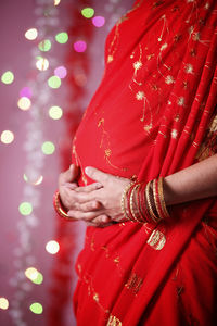 Midsection of woman with red umbrella