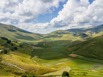 Scenic view of mountains against cloudy sky