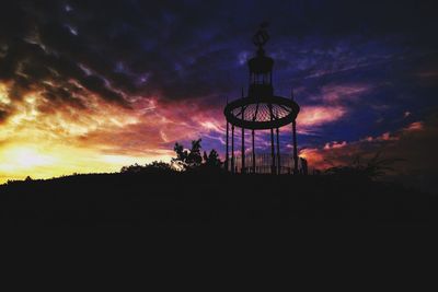 Low angle view of silhouette trees against sky at night