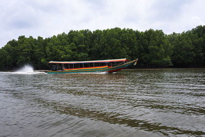 Boat in river against sky