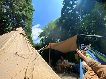 People in tent against sky