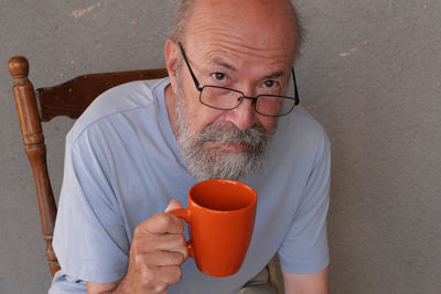 Poor old man drinking coffee 
