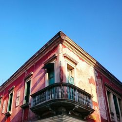 Low angle view of building against clear blue sky
