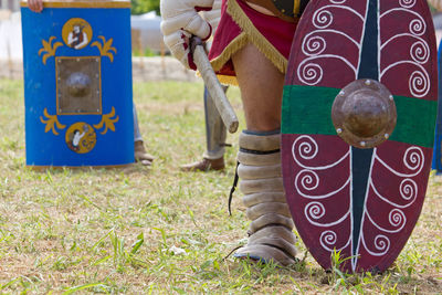 Low section of man standing on field