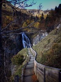 Scenic view of waterfall against sky