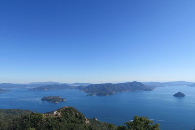 Scenic view of sea against clear blue sky