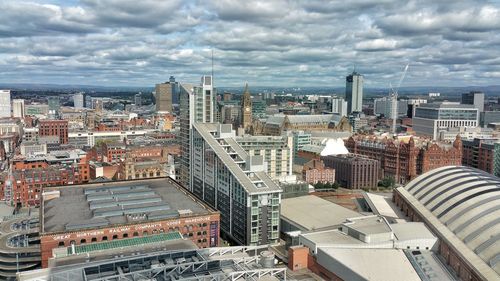 High angle view of modern buildings in city against sky