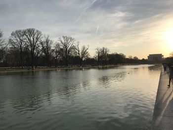 Scenic view of lake against sky at sunset