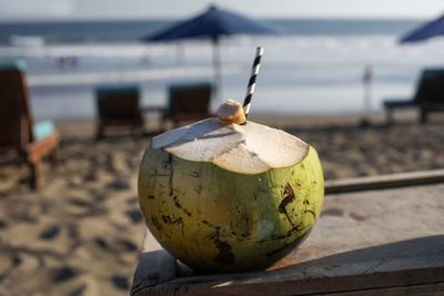 Close-up of apple on beach