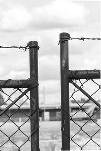 Close-up of metal fence against sky