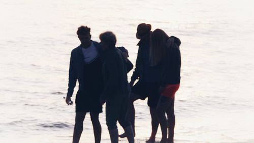 Rear view of couple standing on beach