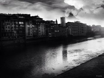 Buildings in city against cloudy sky