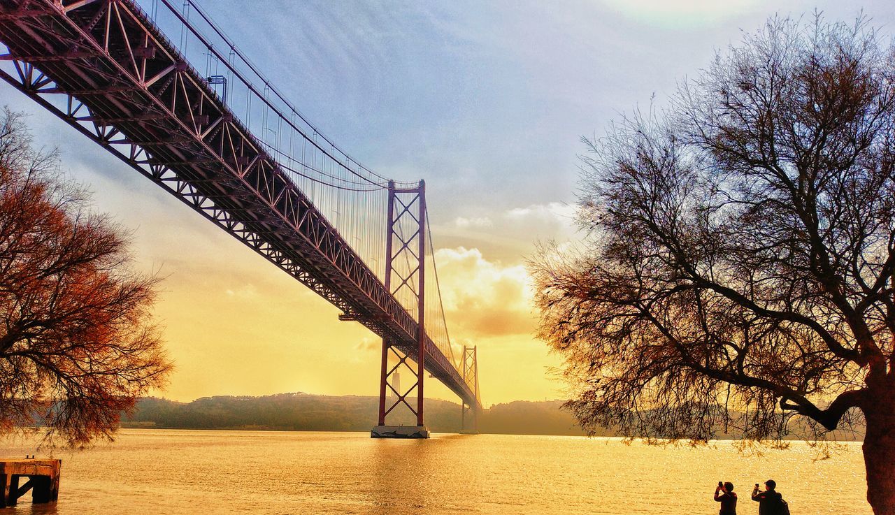 sky, tree, water, bridge, architecture, nature, connection, built structure, bridge - man made structure, plant, cloud - sky, sunset, bare tree, engineering, transportation, outdoors, day, waterfront