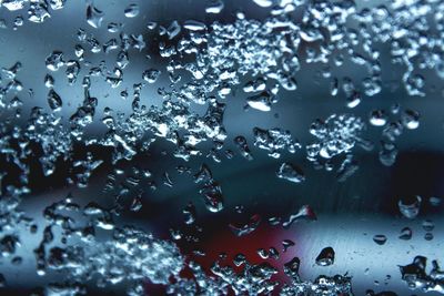 Full frame shot of wet glass window in rainy season