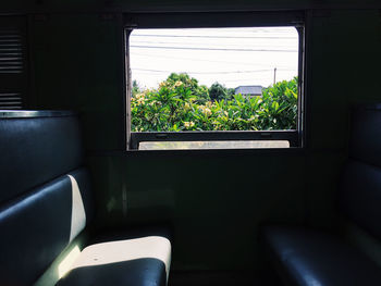 Empty chair seen through window