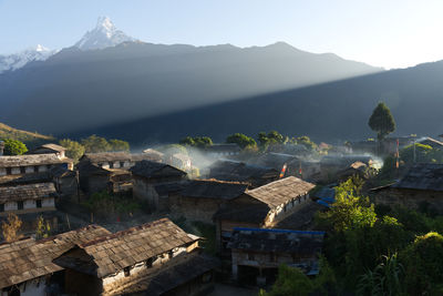 Houses on mountain against sky