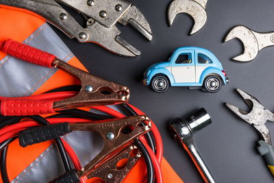 High angle view of toy car with hand tools on table