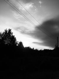 Low angle view of silhouette trees on field against sky