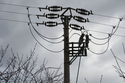 Low angle view of electricity pylon against sky