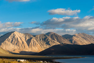 Scenic view of mountains against cloudy sky