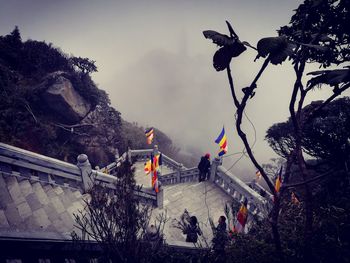 People on mountain against sky