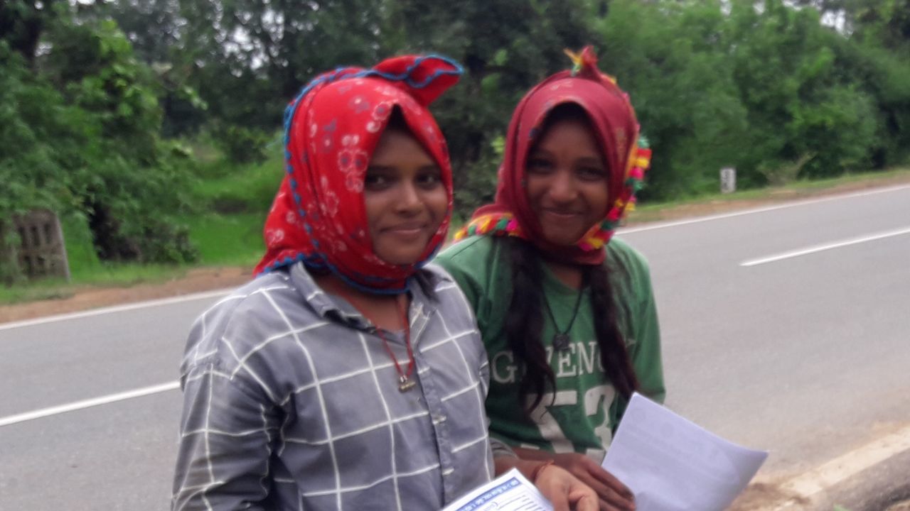 two people, road, adult, togetherness, young adult, women, portrait, transportation, day, smiling, men, emotion, tree, holding, waist up, clothing, city, plant, person, street, communication, front view, casual clothing, looking at camera, happiness, standing, nature, friendship, outdoors, bonding, lifestyles, female, looking, focus on foreground