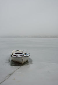 Old boat at frozen lake orestiada in kastoria,greece