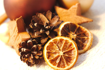 Close-up of dried citrus fruits with christmas decoration on table
