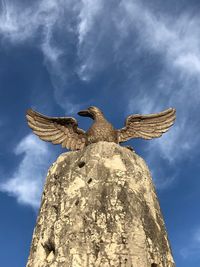 Low angle view of statue against sky