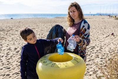 Mother and son recycling platic